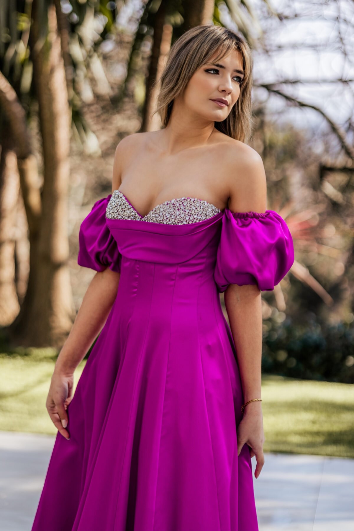 Modelo fúcsia com mangas volumosas e silhueta feminina para um look marcante.