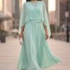 Vestido midi verde água com capa fluida e tecido leve em movimento